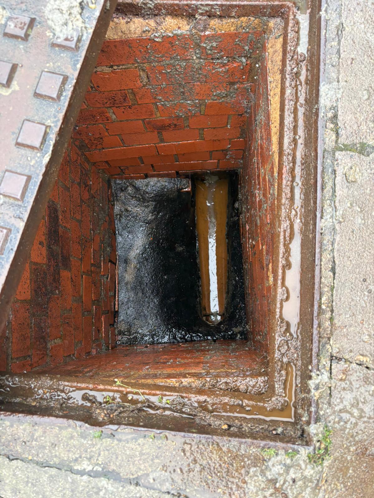 The same brick manhole cleared and restored after works