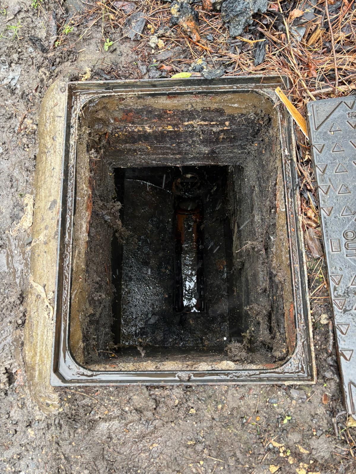 Open drainage inspection chamber in the ground ready for a pump-station service in Kent, Surrey, Sussex, Essex & London