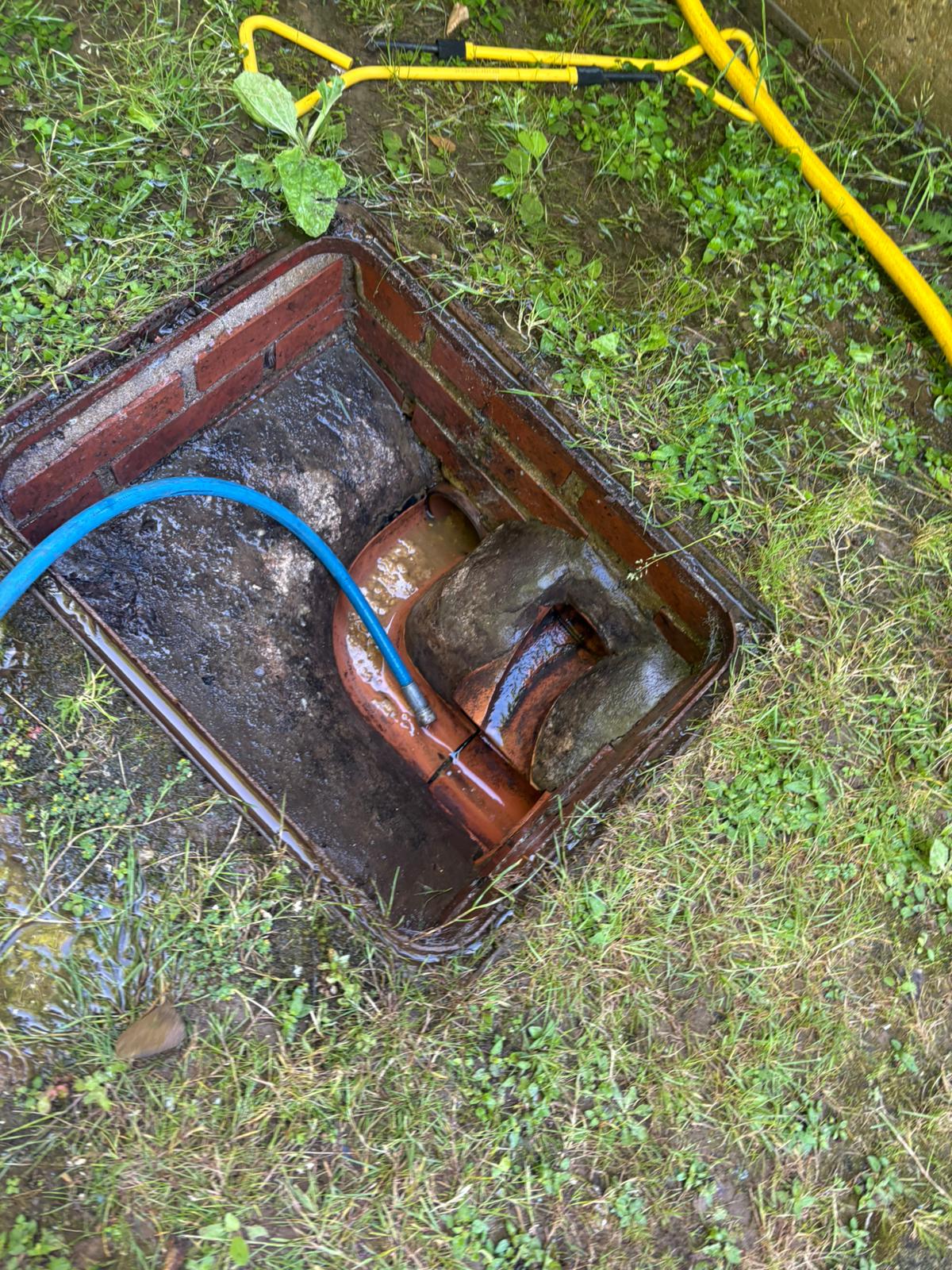 Close-up of a drain jetting hose in an inspection chamber during descaling in Kent, Surrey, Sussex, Essex & London