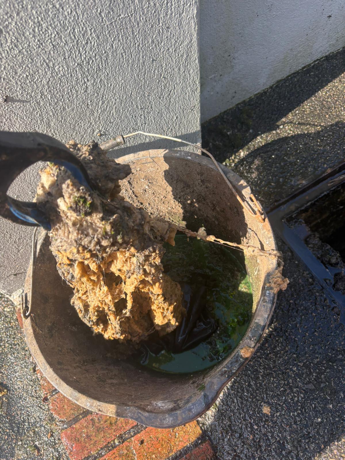 Blocked gully filled with silt and debris being cleared in Kent, Surrey, Sussex, Essex & London