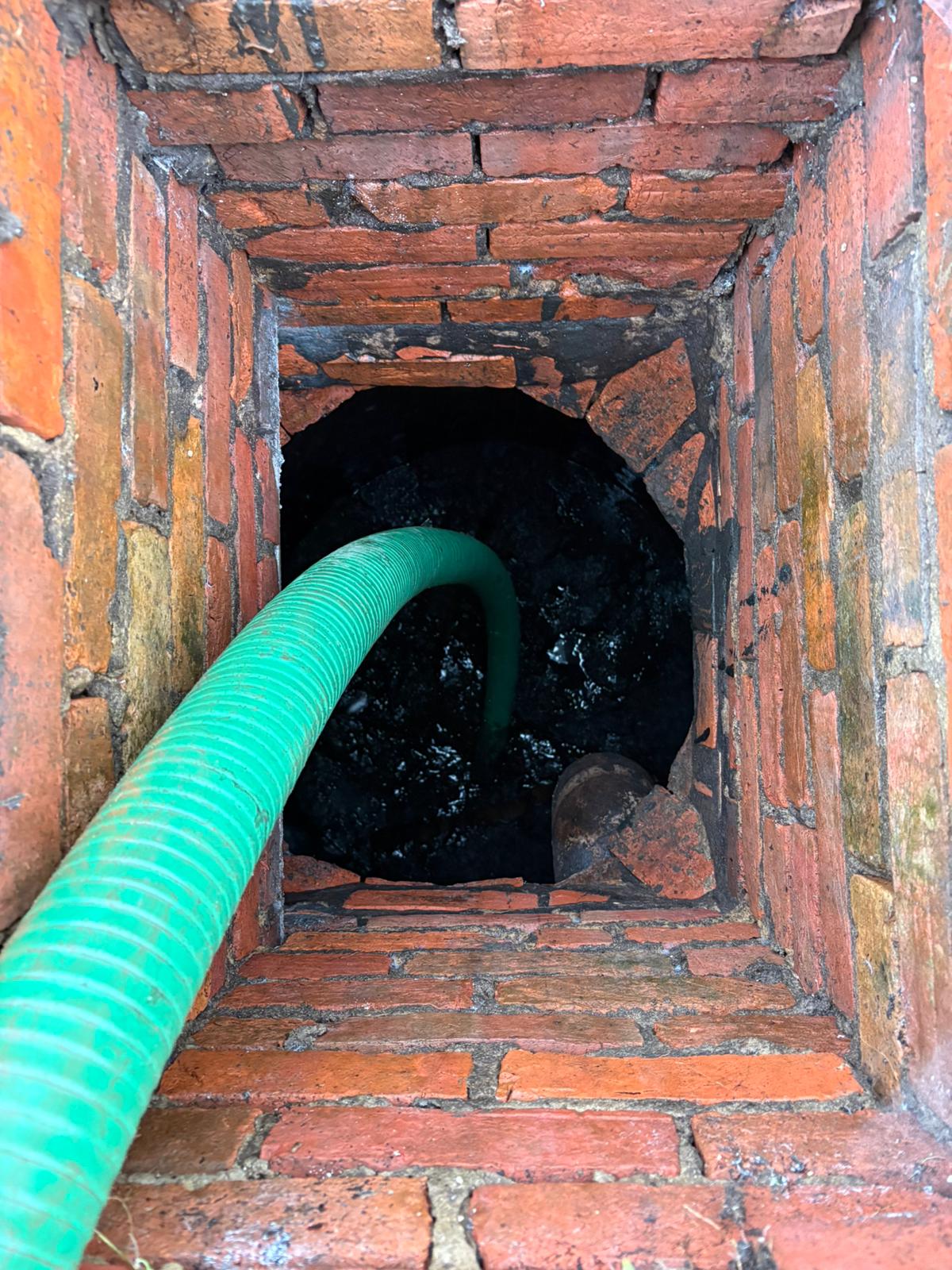 Vacuum tanker pumping out a brick sewer channel during gully work in Kent, Surrey, Sussex, Essex & London