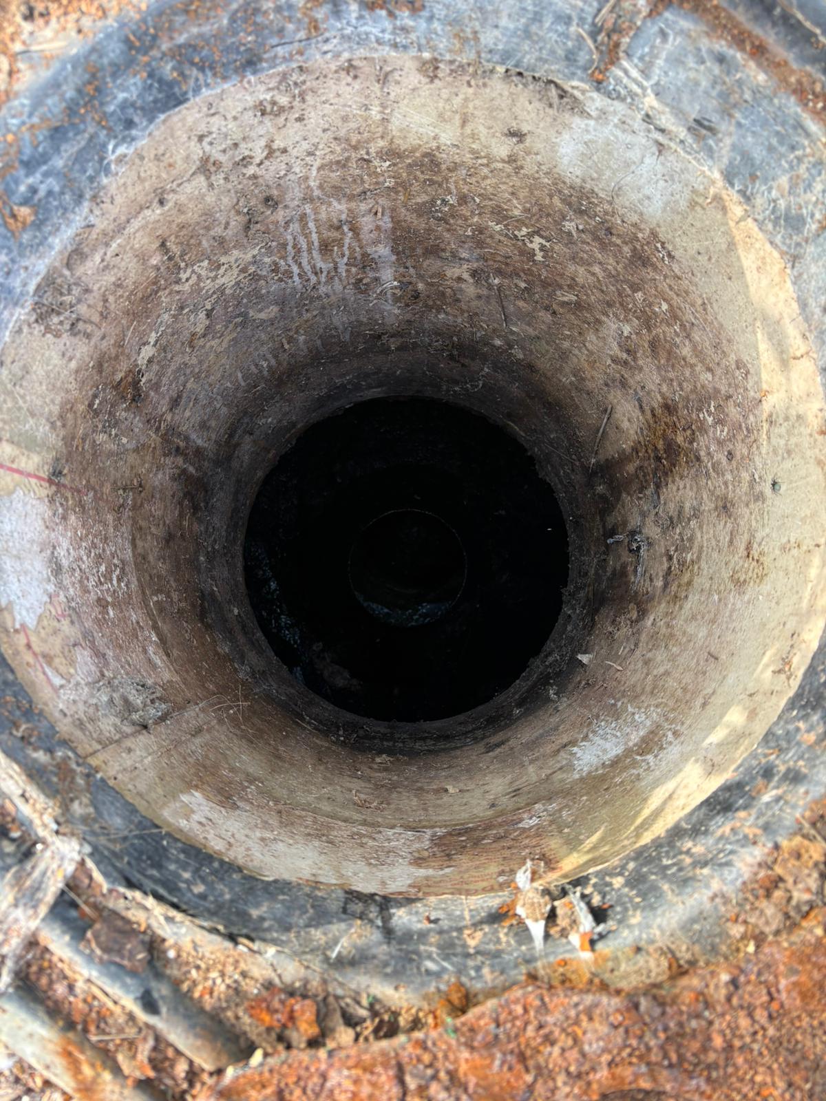 Deep brick cesspit chamber being inspected in Kent