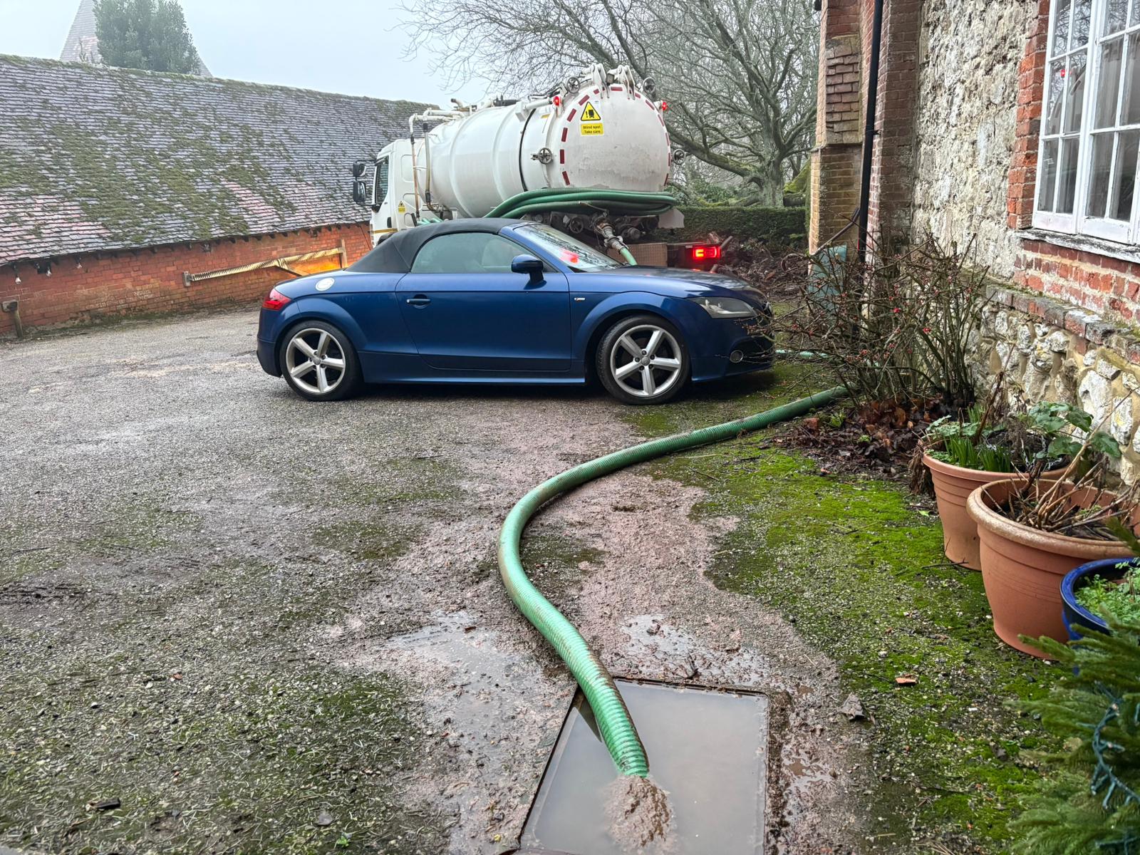 Vacuum tanker emptying a septic tank at a residential property in Kent, Surrey, Sussex, Essex & London